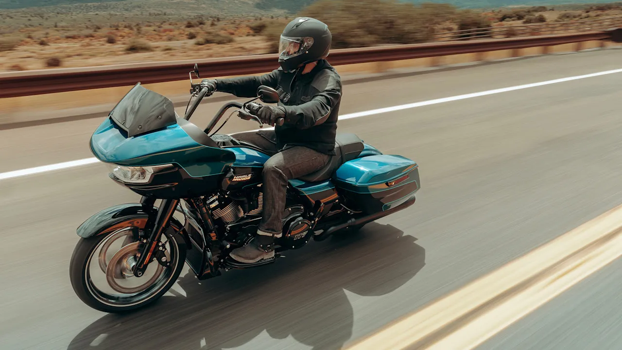A group of Harley-Davidson motorcycles riding on the historic Route 66 in Arizona during the centennial celebration