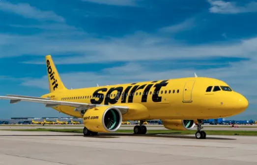 Spirit budget airline planes parked at a terminal gate