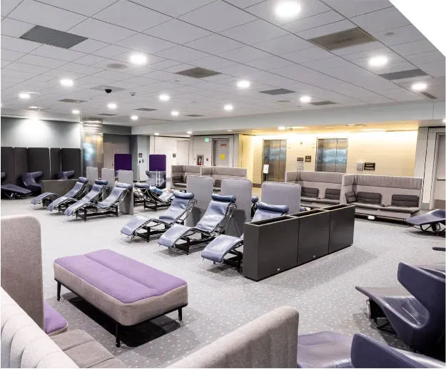 Comfortable lounge chairs in the free Rest and Recharge area located on the Concourse A mezzanine at Denver Airport