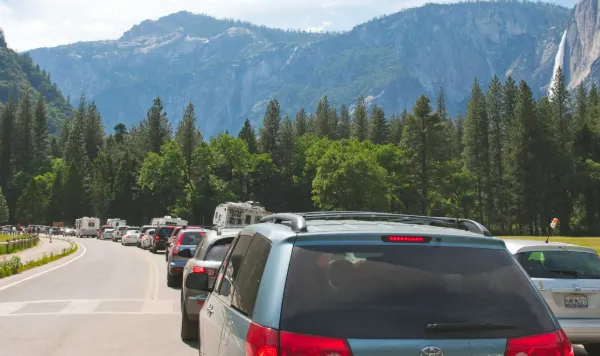 A long line of cars stuck in morning traffic trying to enter Yosemite National Park without a reservation
