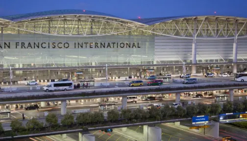 The exterior of the San Francisco International Airport SFO terminal building with cars arriving