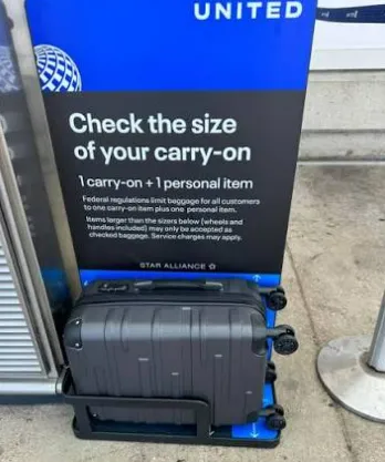 A United Airlines gate agent measuring a carry-on bag for basic economy passengers who do not hold a co-branded credit card